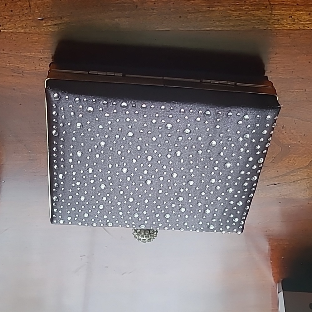 Grey evening bag with a rhinestone knob. Satin finish plain back, jeweled front.